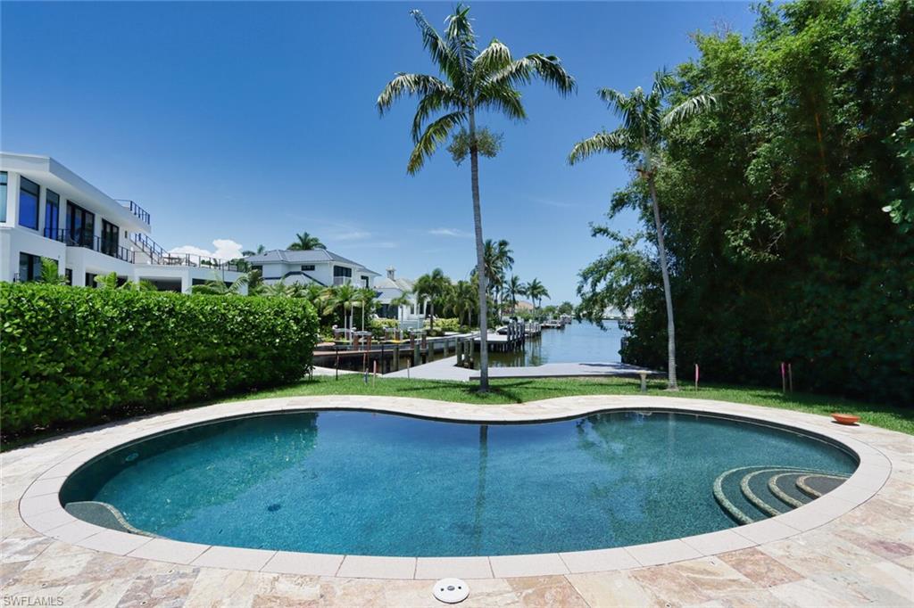 2201 Beacon Lane Naples, FL 34103 - Photo 35 of 41 a view of a swimming pool with a yard