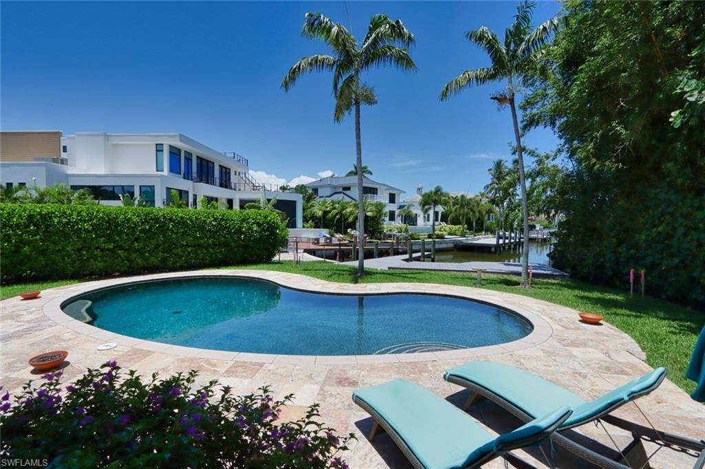 2201 Beacon Lane Naples, FL 34103 - Photo 37 of 41 a view of a swimming pool with a yard