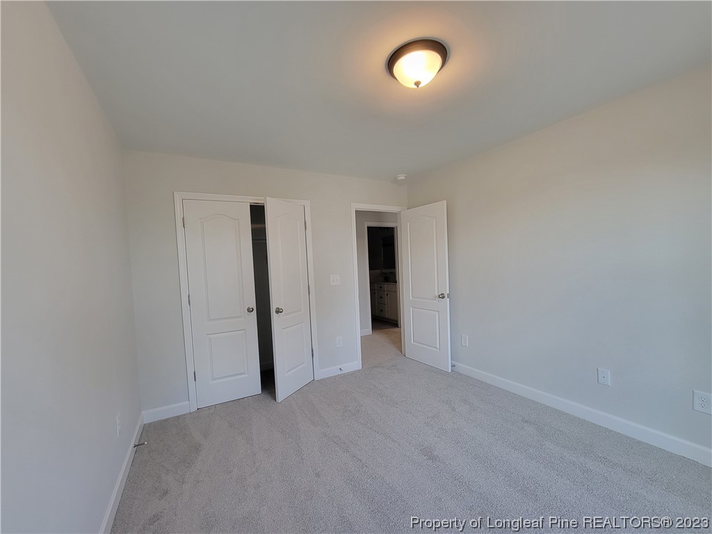 187 Timber Skip Drive Spring Lake, NC 28390 - Photo 18 of 20 an empty room with an entryway and closet