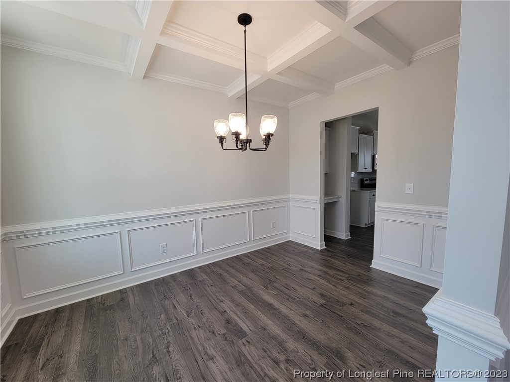 187 Timber Skip Drive Spring Lake, NC 28390 - Photo 3 of 20 a view of an empty room with wooden floor and kitchen view