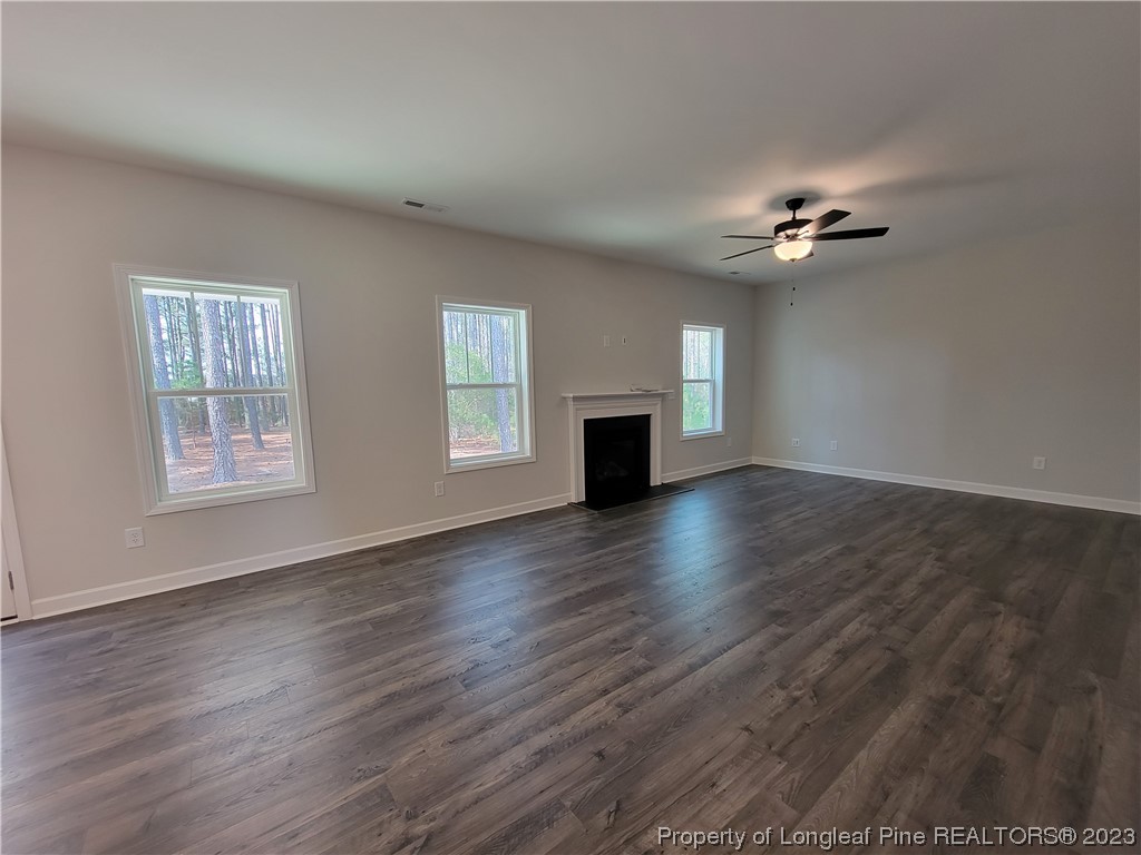 187 Timber Skip Drive Spring Lake, NC 28390 - Photo 6 of 20 a view of empty room with a fireplace and wooden floor