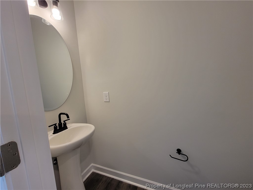 187 Timber Skip Drive Spring Lake, NC 28390 - Photo 7 of 20 a bathroom with a sink and mirror