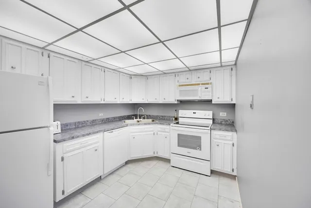 a kitchen with stainless steel appliances granite countertop a sink and cabinets