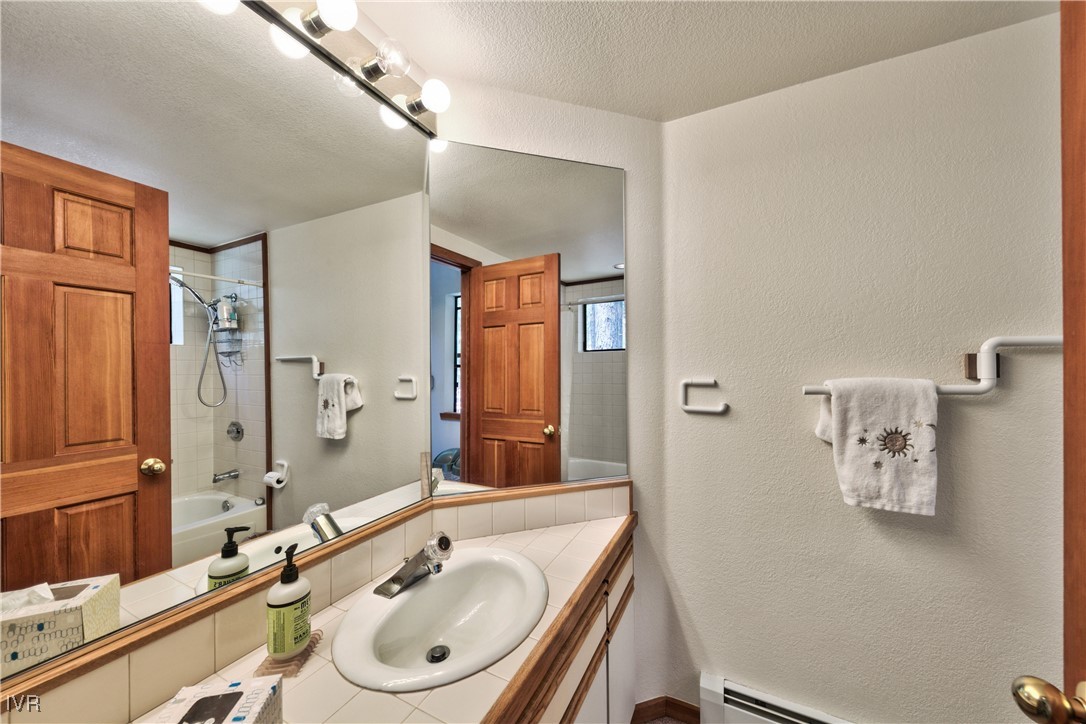 609 Lariat Circle, Unit 2 Incline Village, NV 89451 - Photo 17 of 24 a bathroom with a granite countertop sink toilet and shower