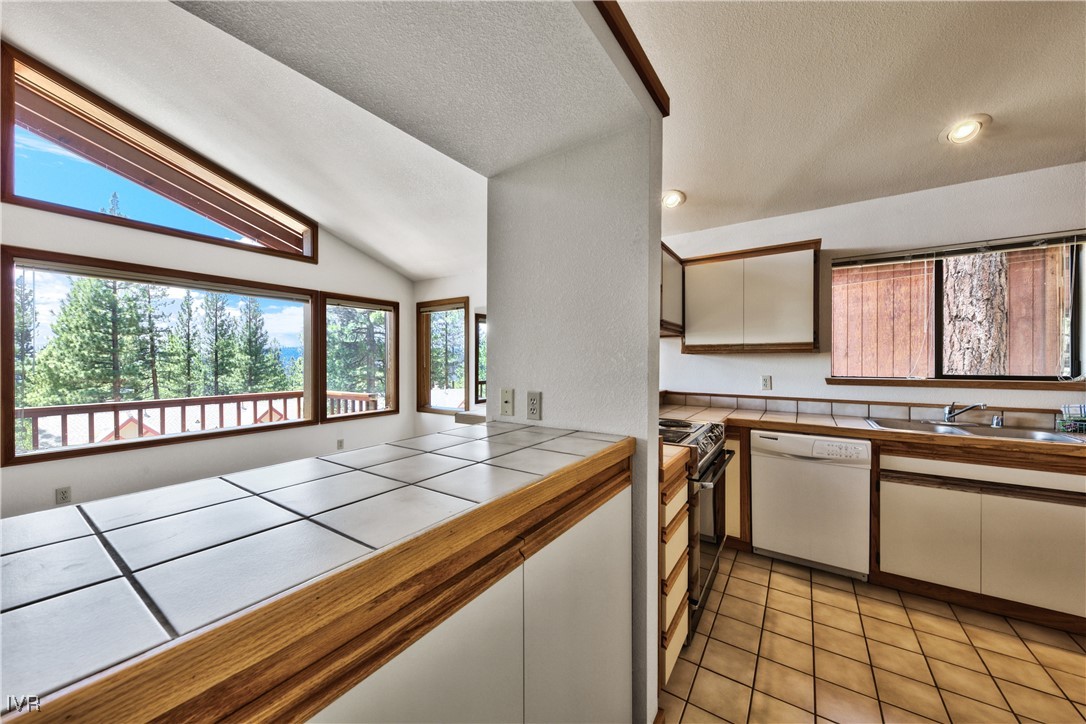 609 Lariat Circle, Unit 2 Incline Village, NV 89451 - Photo 8 of 24 a open kitchen with stainless steel appliances granite countertop a sink and cabinets