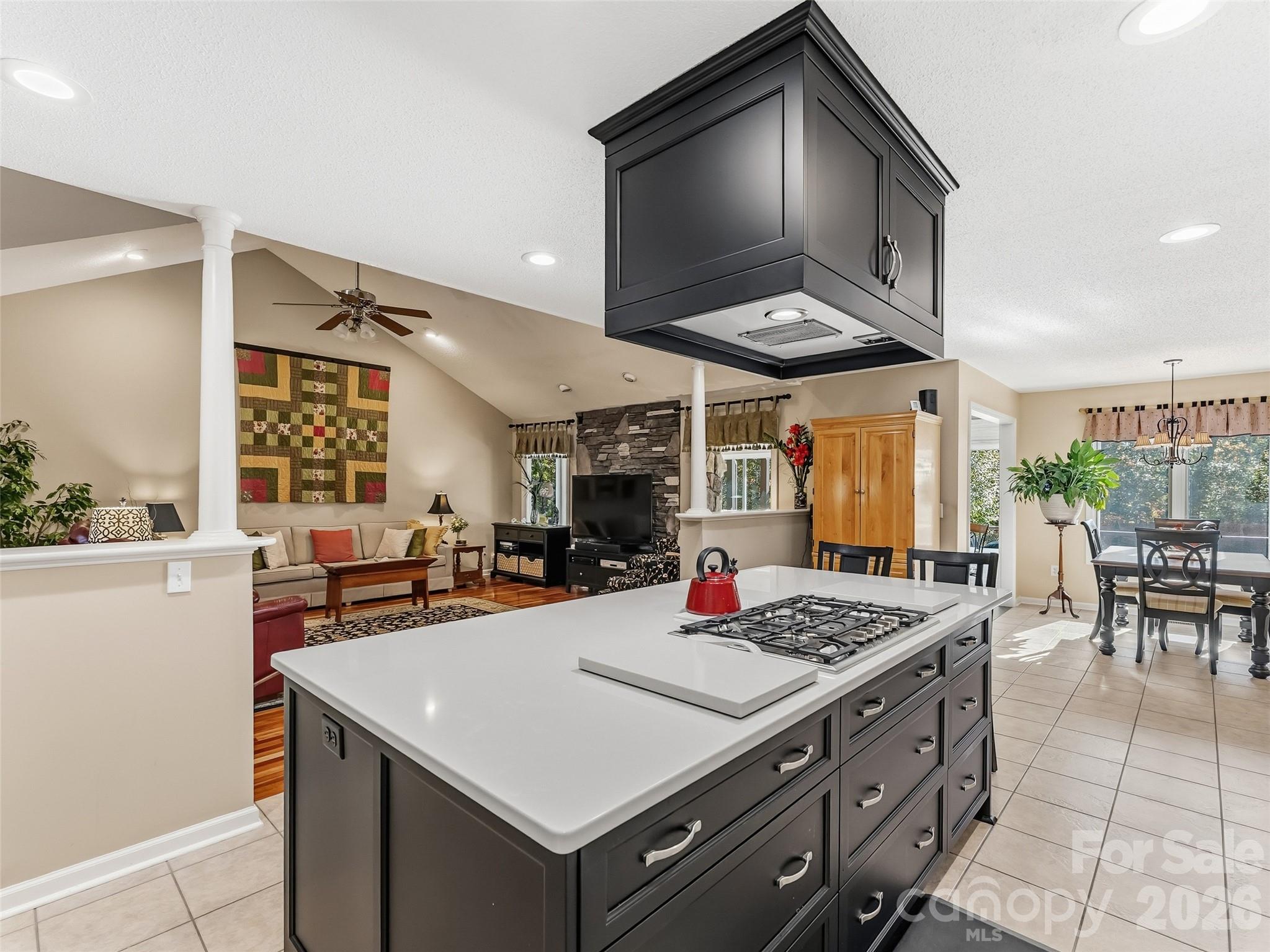 1340 Macedonia Road Saluda, NC 28773 - Photo 17 of 45 a kitchen with a stove a table and chairs in it