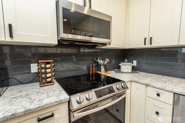 a kitchen with granite countertop a stove and a sink
