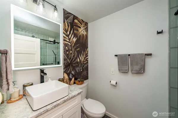 a white toilet sitting next to a bathroom sink