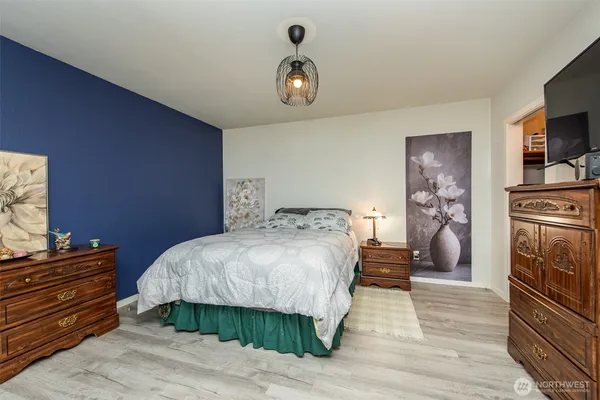 a bedroom with a bed and a chandelier