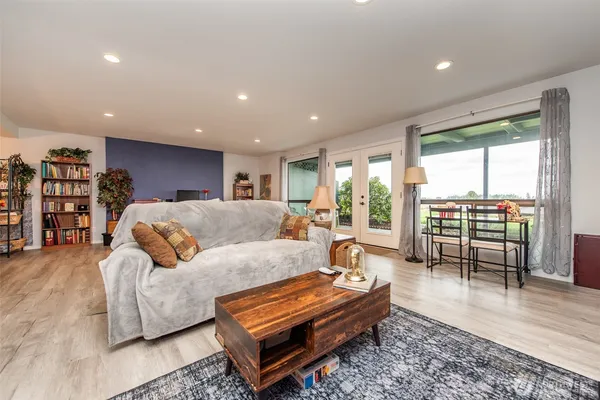 a living room with furniture and a wooden floor