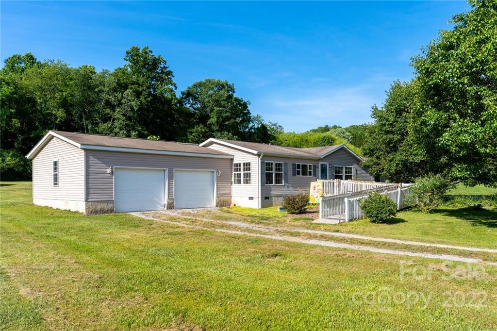 48 Lynn Estate Road Hendersonville, NC 28792 - Photo 1 of 23 a front view of house with yard and trees in the background