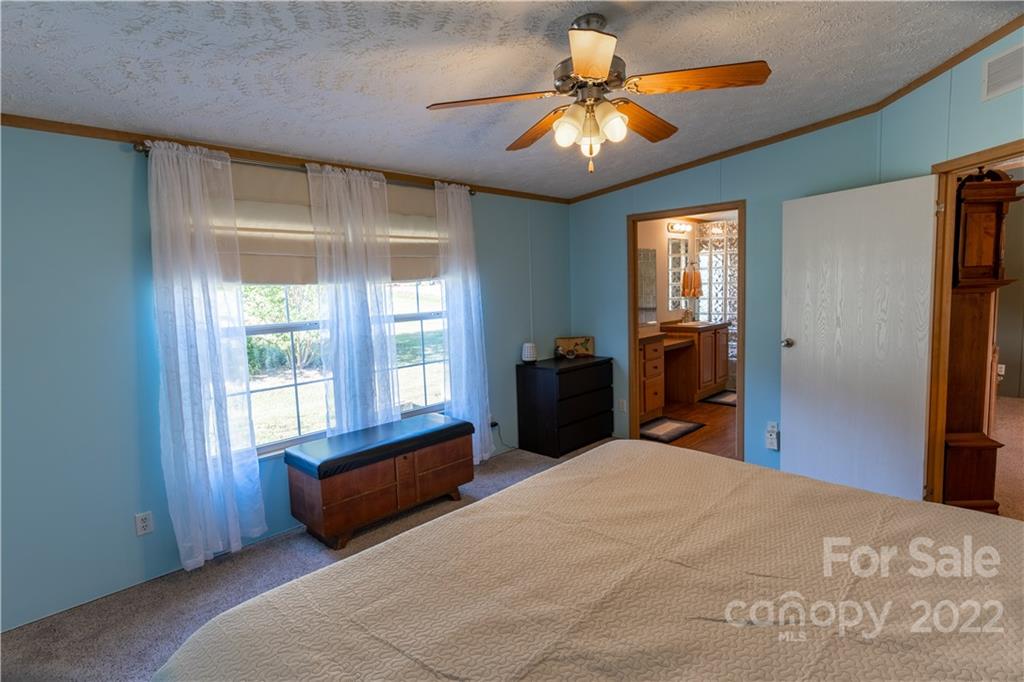 48 Lynn Estate Road Hendersonville, NC 28792 - Photo 15 of 23 a bed room with a bed and a chandelier