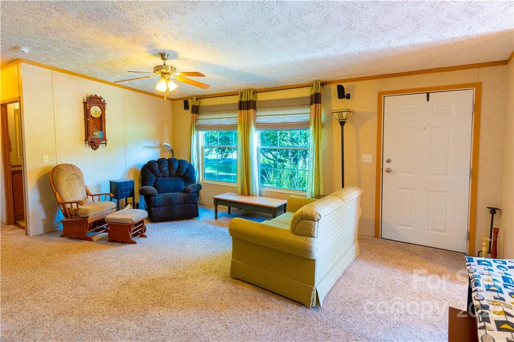 48 Lynn Estate Road Hendersonville, NC 28792 - Photo 5 of 23 a living room with furniture a chandelier and a window