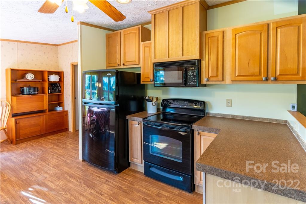 48 Lynn Estate Road Hendersonville, NC 28792 - Photo 10 of 23 a kitchen with stainless steel appliances granite countertop a stove a refrigerator and a sink