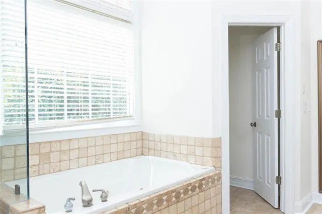 a bathroom with a granite countertop sink a mirror and a shower