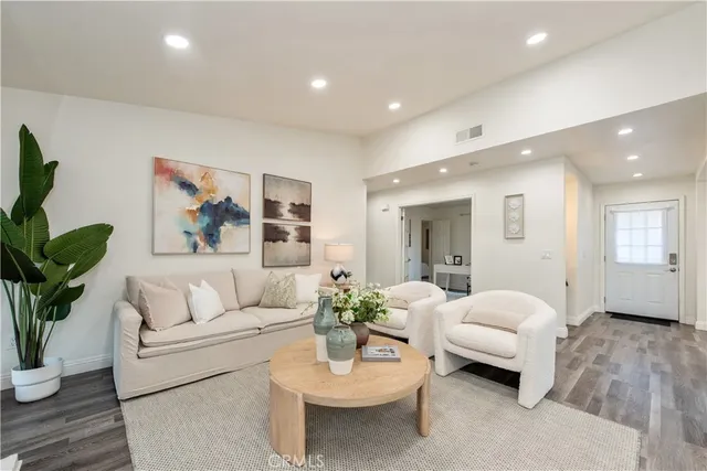 a living room with furniture and a potted plant