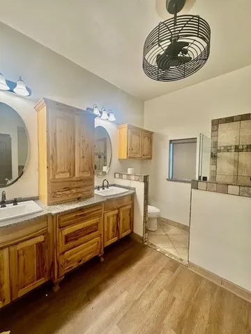 a spacious bathroom with a double vanity sink and a mirror