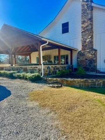 a front view of a house with a yard and swimming pool