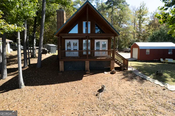a view of wooden house with a yard