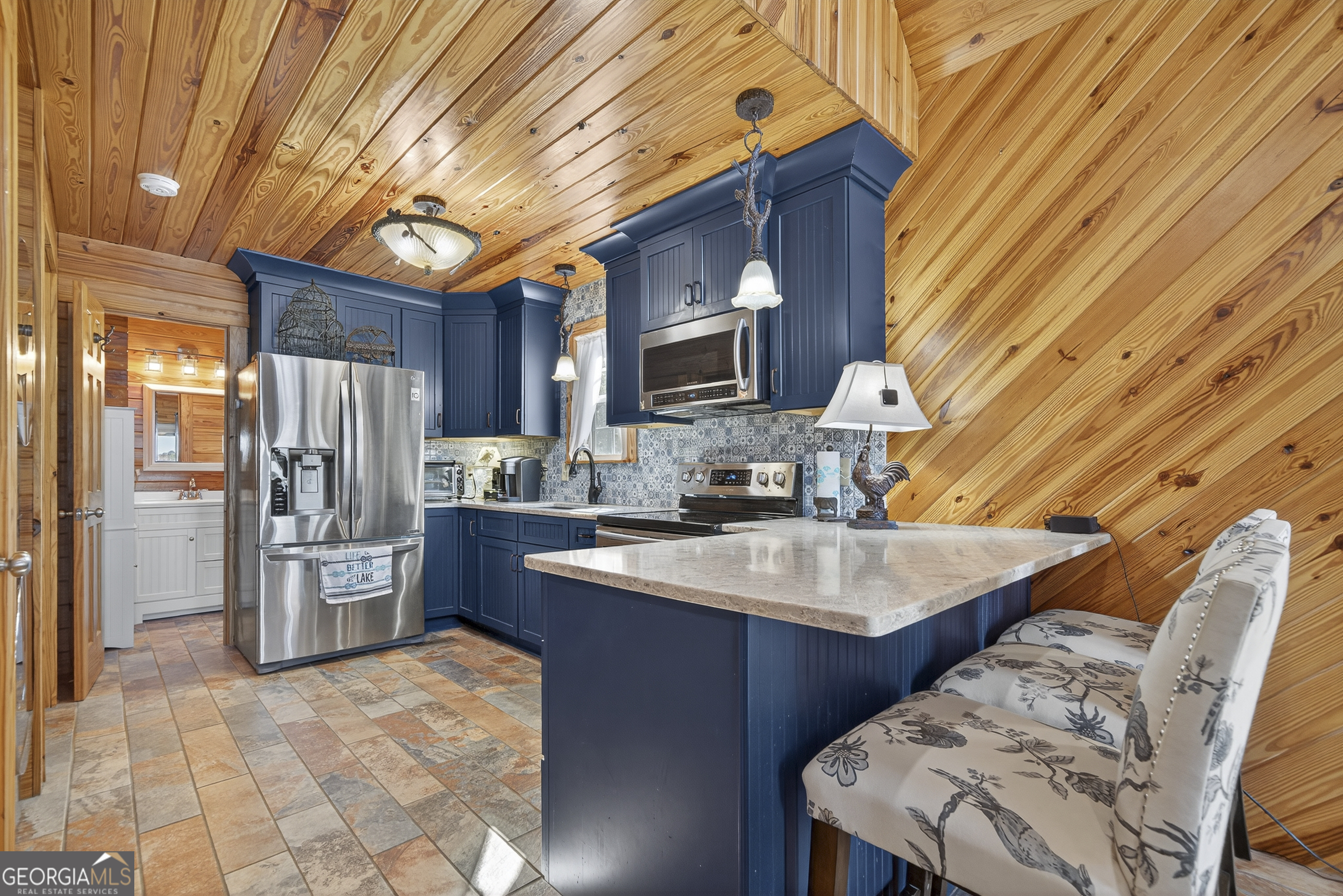 955 Barbara Point Road Sparta, GA 31087 - Photo 13 of 54 a kitchen with stainless steel appliances granite countertop a sink a stove counter space and cabinets