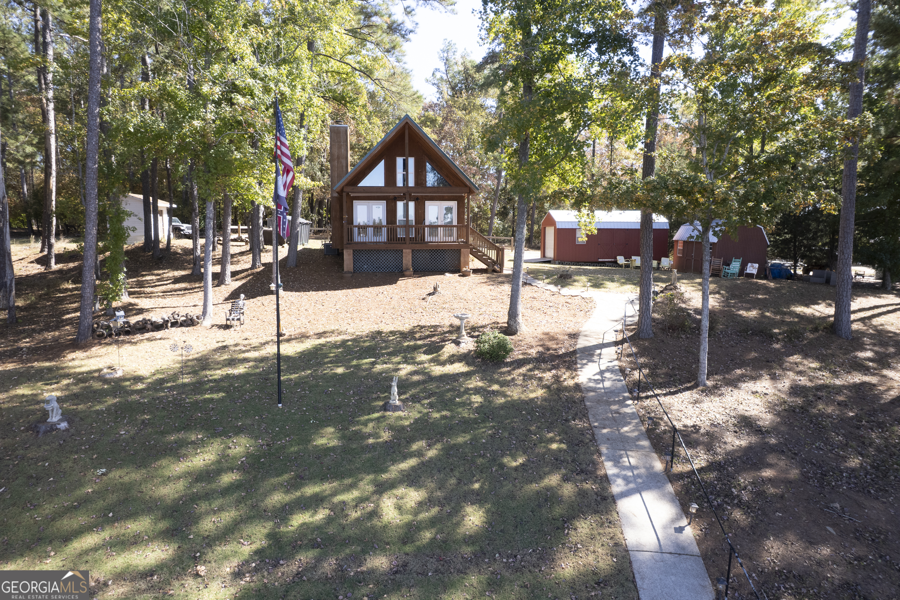 955 Barbara Point Road Sparta, GA 31087 - Photo 2 of 54 a street view covered with tall trees