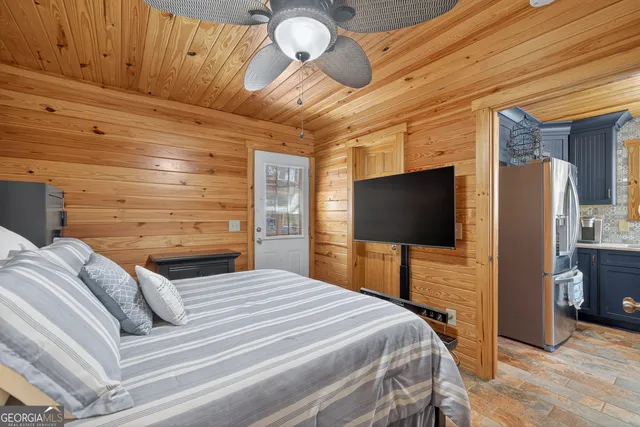 a bedroom with a bed and a flat screen tv