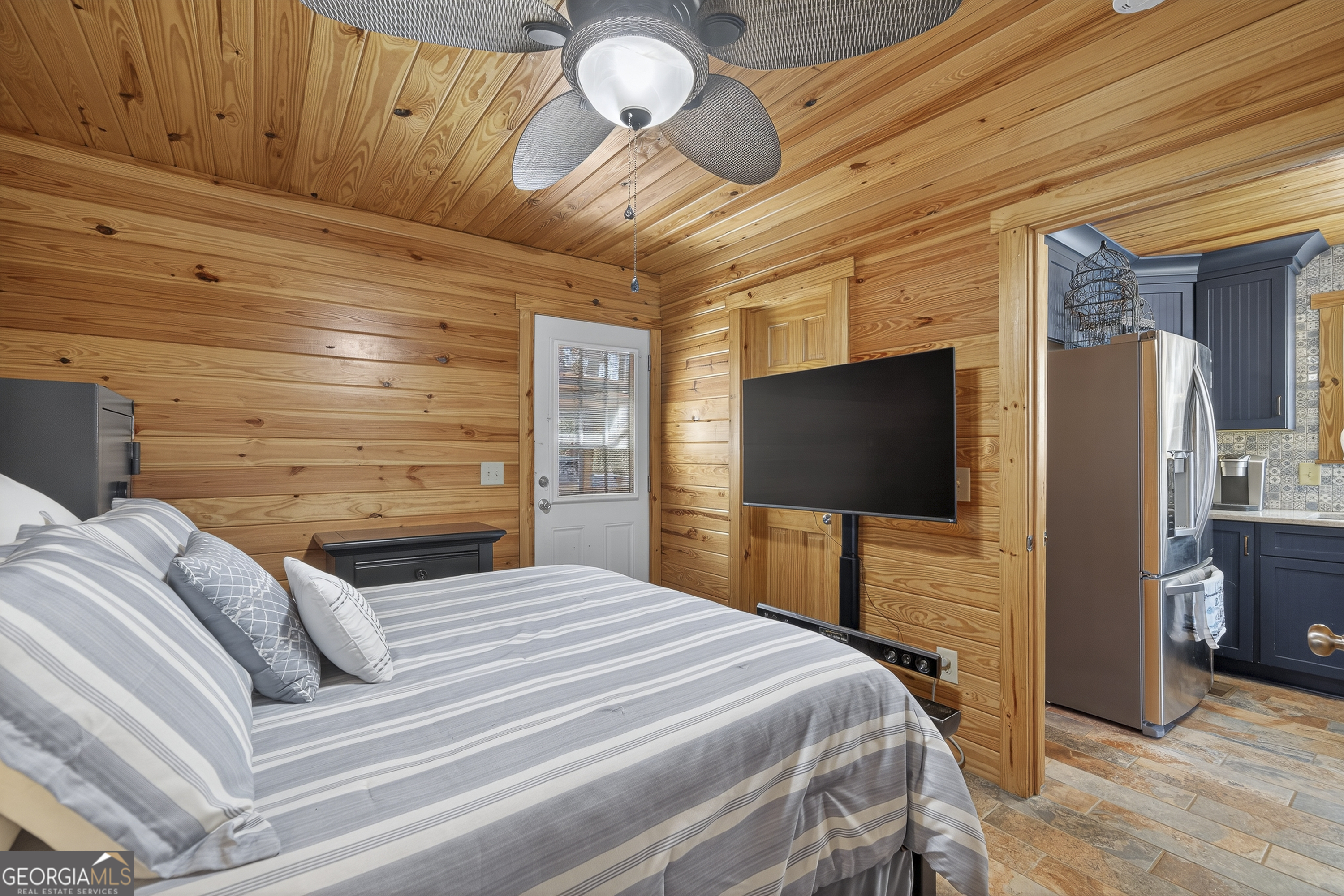 955 Barbara Point Road Sparta, GA 31087 - Photo 23 of 54 a bedroom with a bed and a flat screen tv