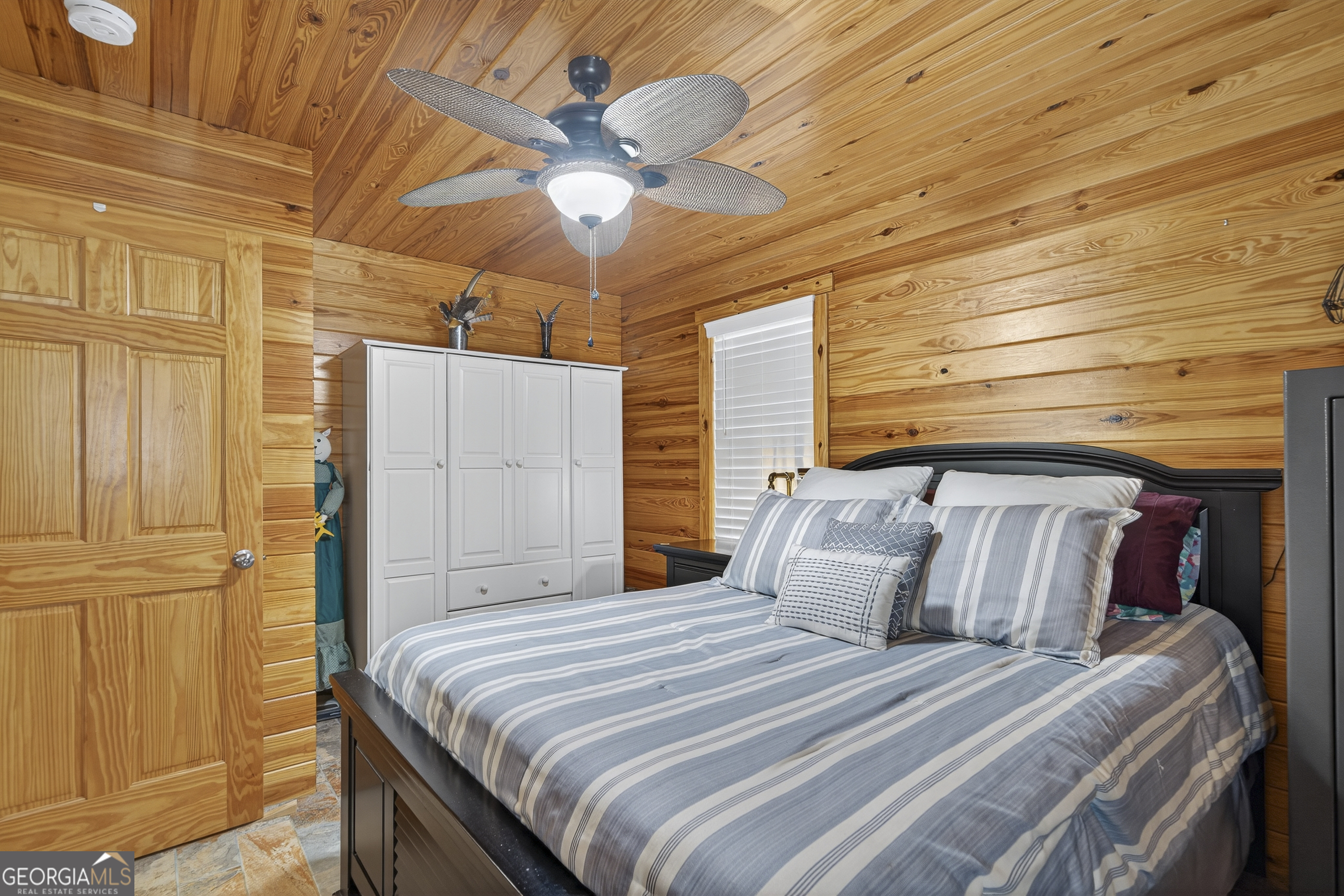 955 Barbara Point Road Sparta, GA 31087 - Photo 24 of 54 a bedroom with a bed and a chandelier