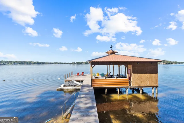 a roof deck with a table and a potted plants