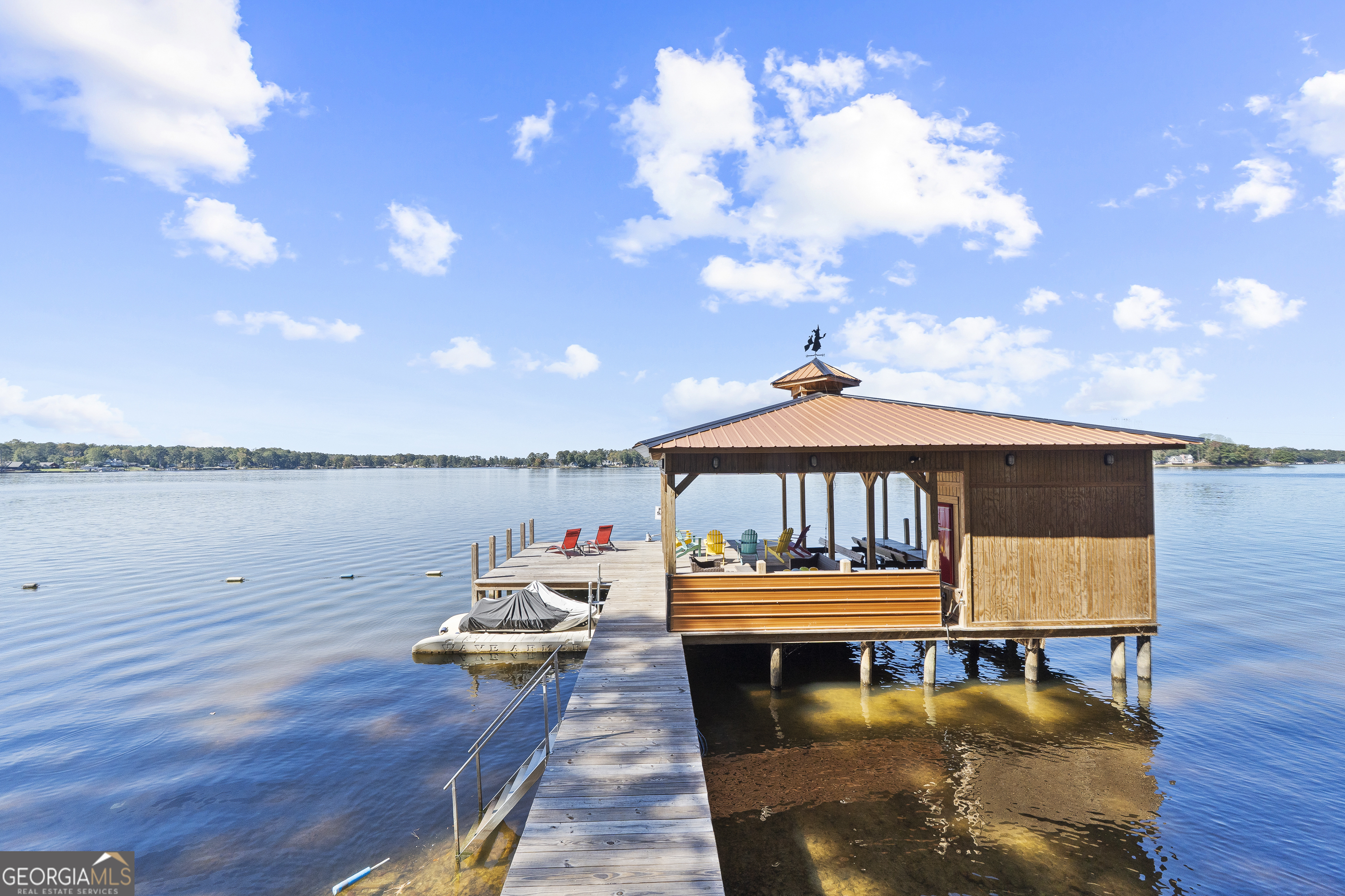 955 Barbara Point Road Sparta, GA 31087 - Photo 3 of 54 a roof deck with a table and a potted plants