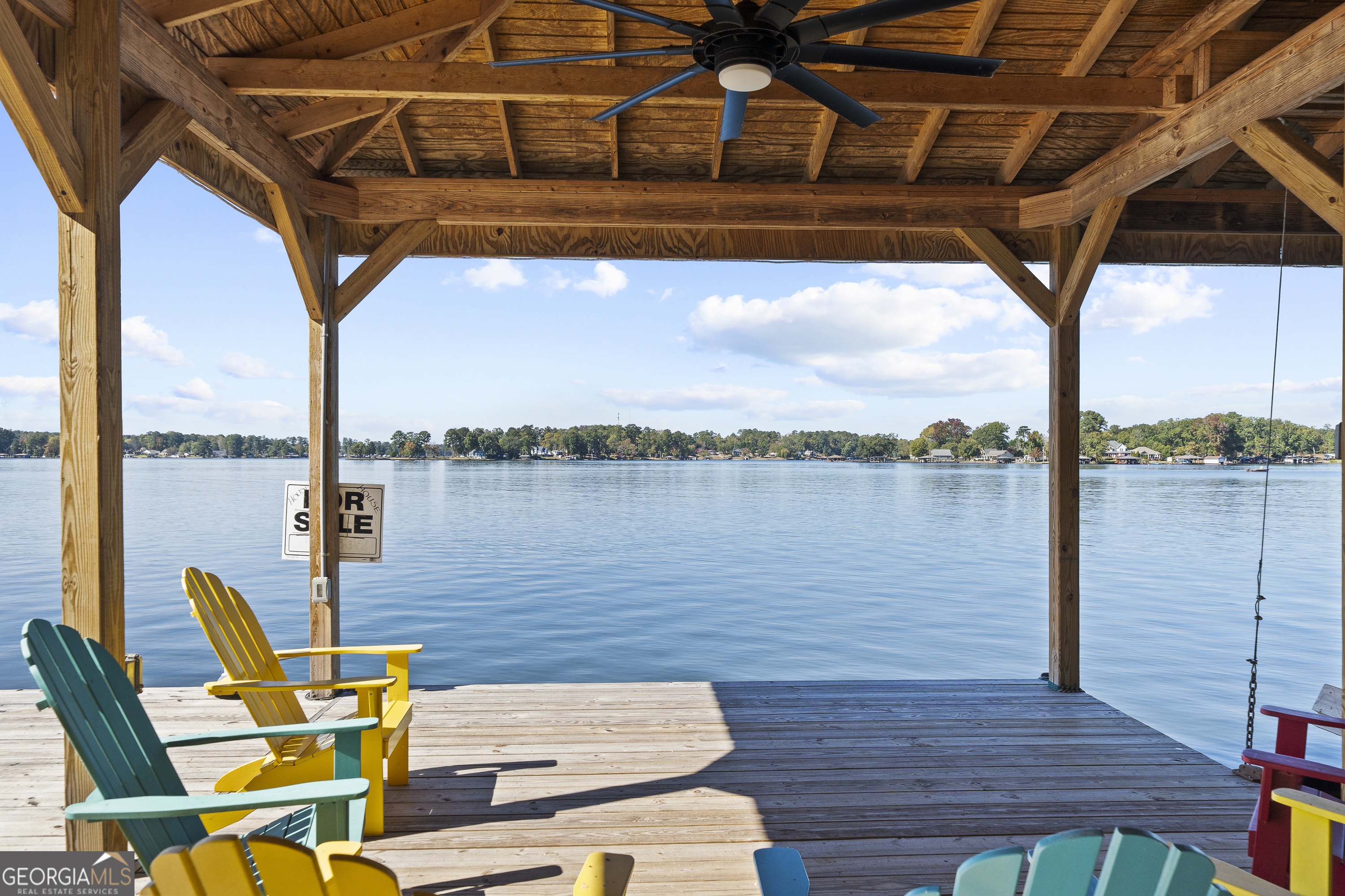 955 Barbara Point Road Sparta, GA 31087 - Photo 46 of 54 a blue chair and table sitting on a terrace