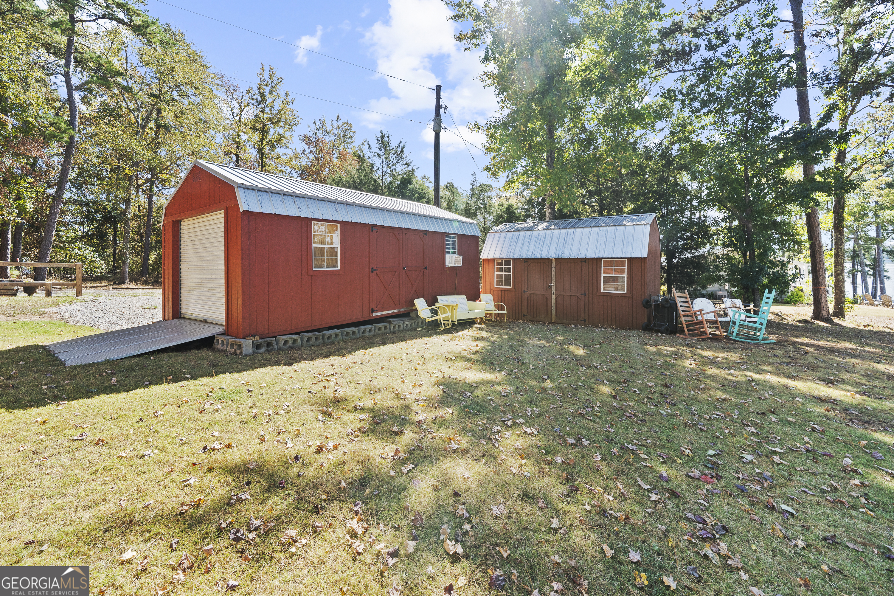 955 Barbara Point Road Sparta, GA 31087 - Photo 48 of 54 a backyard of a house with table and chairs