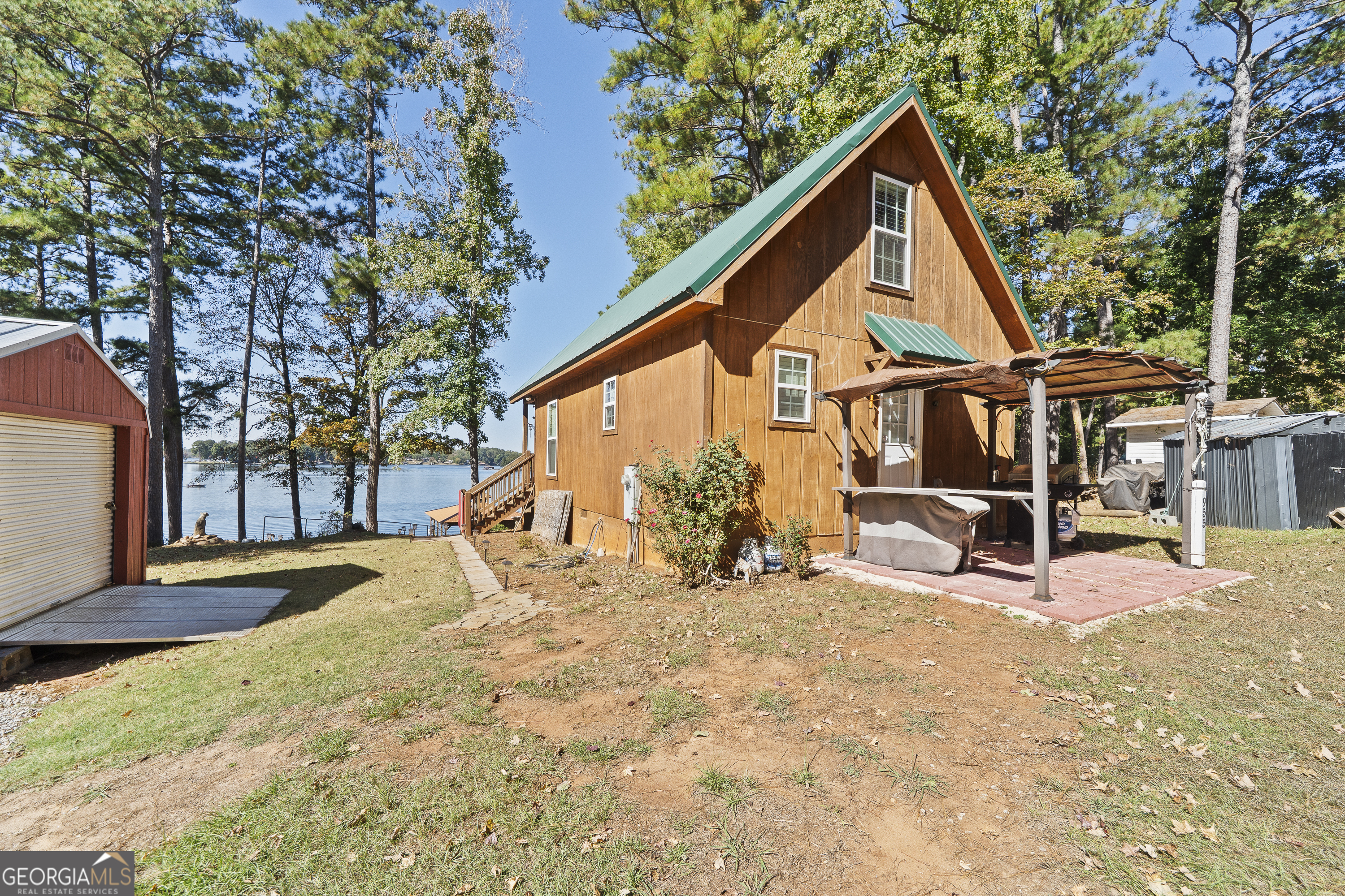 955 Barbara Point Road Sparta, GA 31087 - Photo 49 of 54 a view of a house with backyard and sitting area