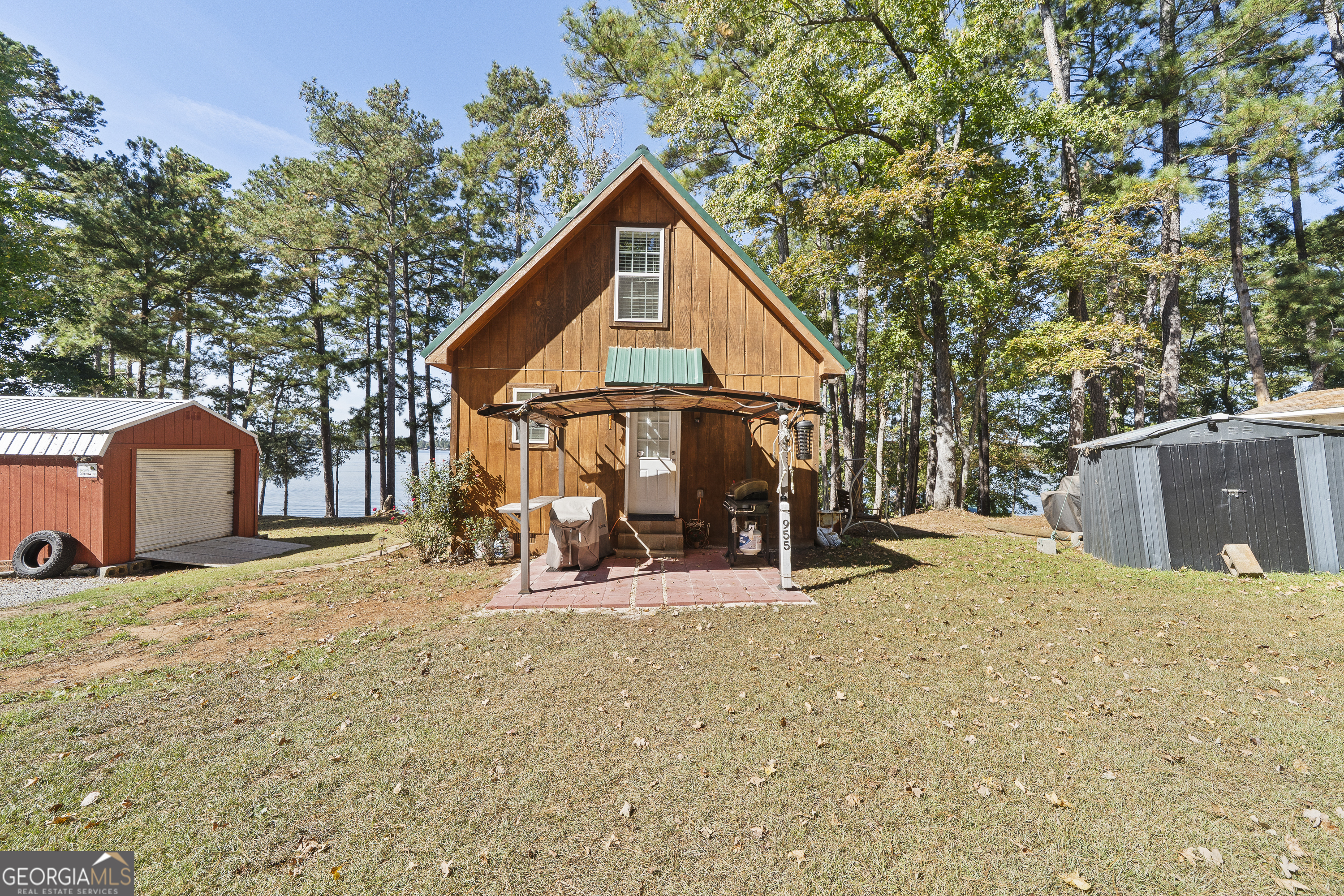 955 Barbara Point Road Sparta, GA 31087 - Photo 50 of 54 a view of a house with a yard patio and backyard