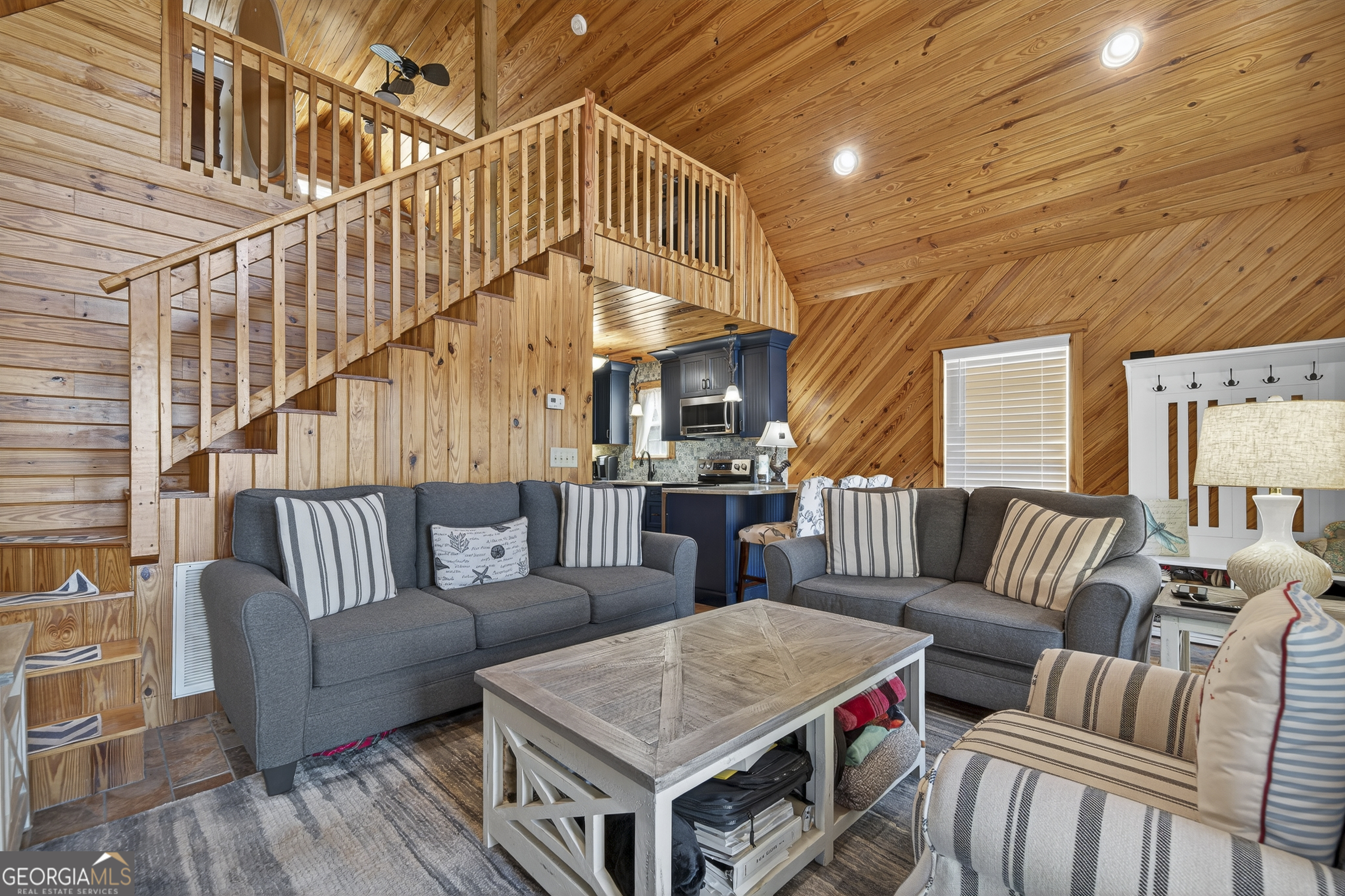 955 Barbara Point Road Sparta, GA 31087 - Photo 7 of 54 a living room with furniture wooden floor and a large window
