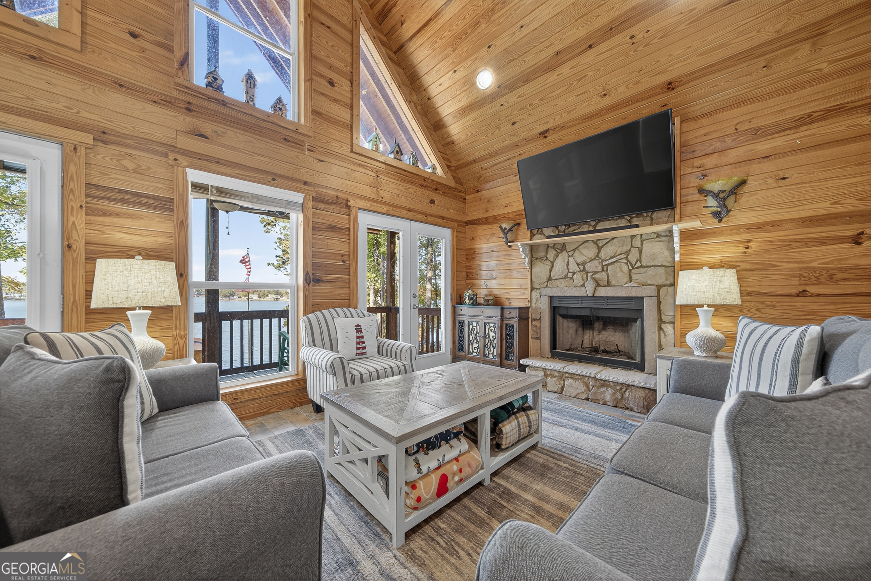 955 Barbara Point Road Sparta, GA 31087 - Photo 8 of 54 a living room with furniture a flat screen tv and a fireplace
