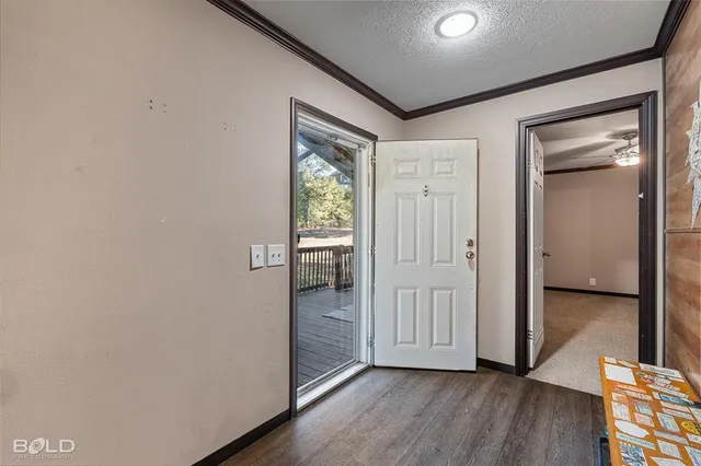 a view of hallway with wooden floor
