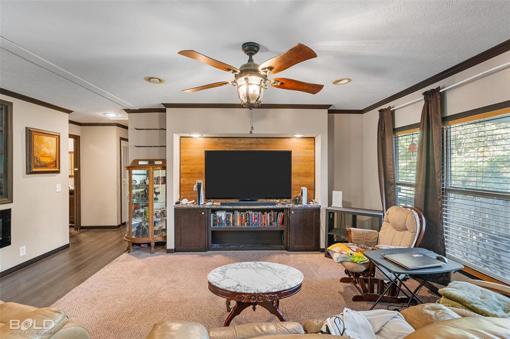 9489 Capps City Road Rodessa, LA 71069 - Photo 14 of 34 a living room with furniture a flat screen tv and a large window