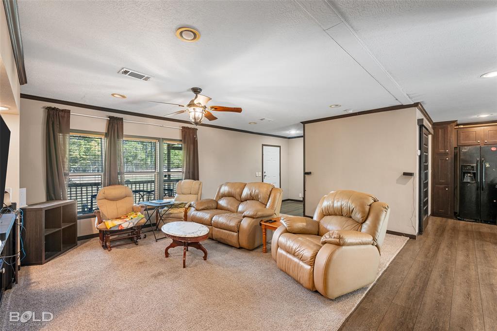 9489 Capps City Road Rodessa, LA 71069 - Photo 16 of 34 a living room with furniture and a large window