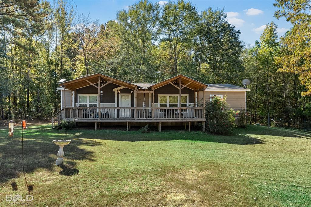 9489 Capps City Road Rodessa, LA 71069 - Photo 2 of 34 a backyard of a house with yard and trampoline