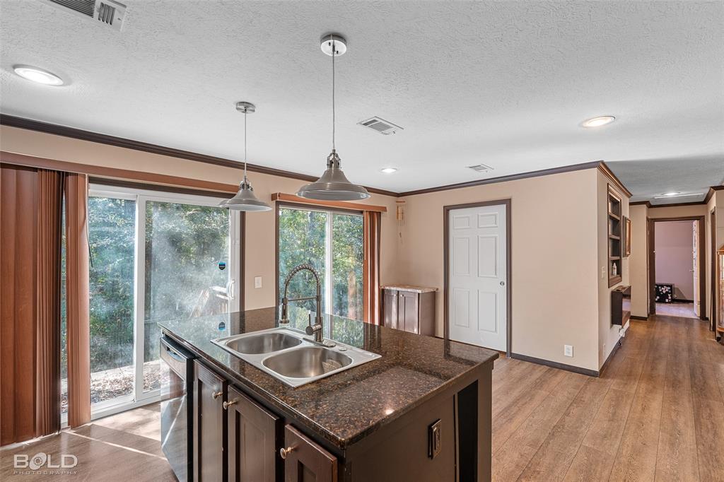 9489 Capps City Road Rodessa, LA 71069 - Photo 23 of 34 a kitchen with stainless steel appliances granite countertop a sink a refrigerator and a stove