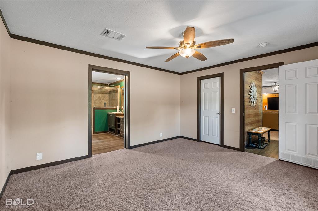 9489 Capps City Road Rodessa, LA 71069 - Photo 25 of 34 an empty room with closet and a chandelier fan