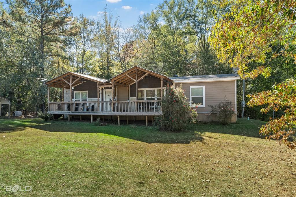 9489 Capps City Road Rodessa, LA 71069 - Photo 4 of 34 a view of a house with a yard and sitting area