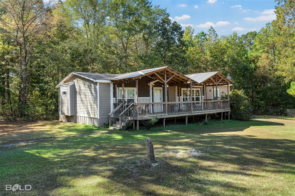 9489 Capps City Road Rodessa, LA 71069 - Photo 6 of 34 a view of a house with a yard and sitting area