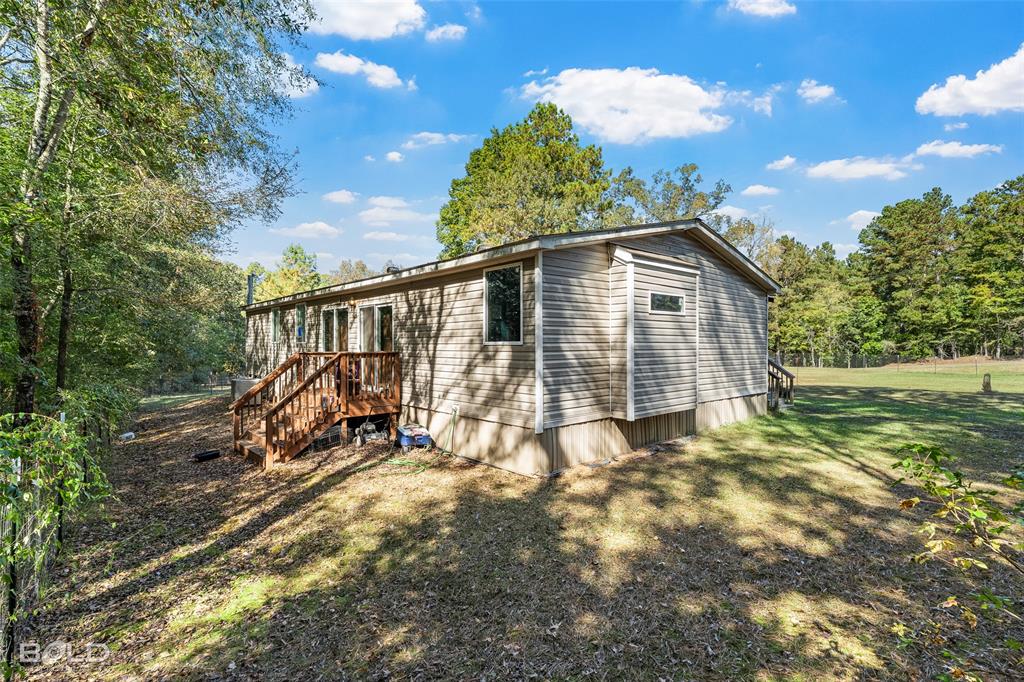 9489 Capps City Road Rodessa, LA 71069 - Photo 8 of 34 a view of backyard with a garden and entertaining space