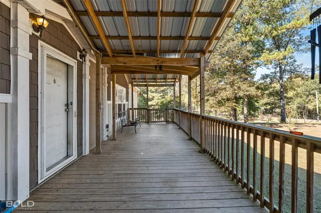a view of a porch with wooden floor and fence