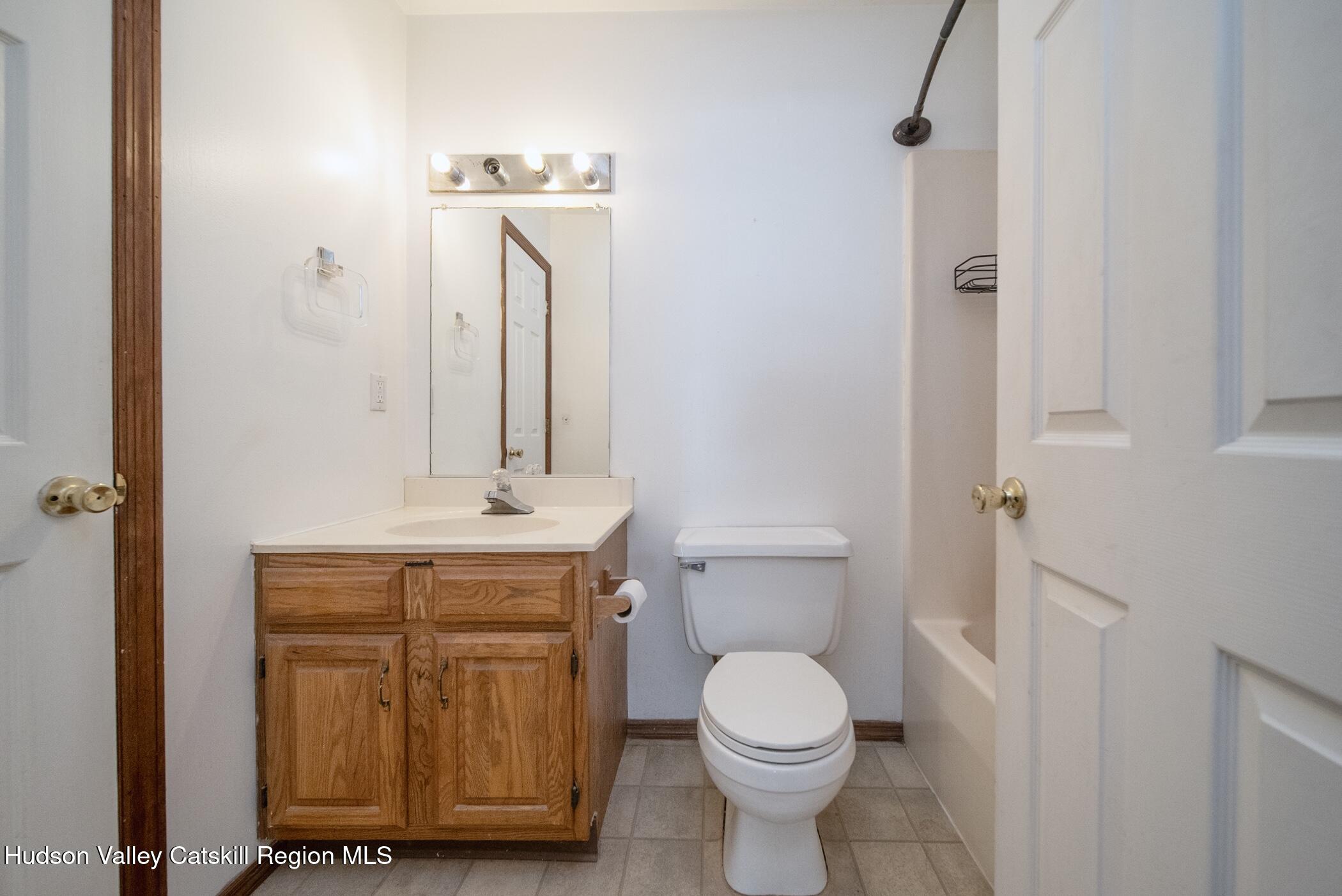 9 Rock Maple Road Saugerties, NY 12477 - Photo 16 of 30 a bathroom with a toilet a sink and mirror