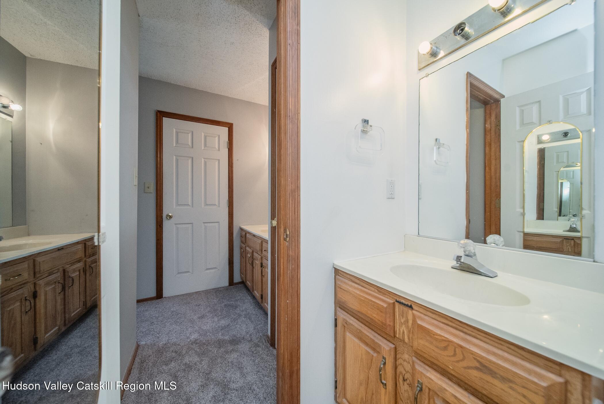9 Rock Maple Road Saugerties, NY 12477 - Photo 18 of 30 a en suite bathroom with a sink and a mirror