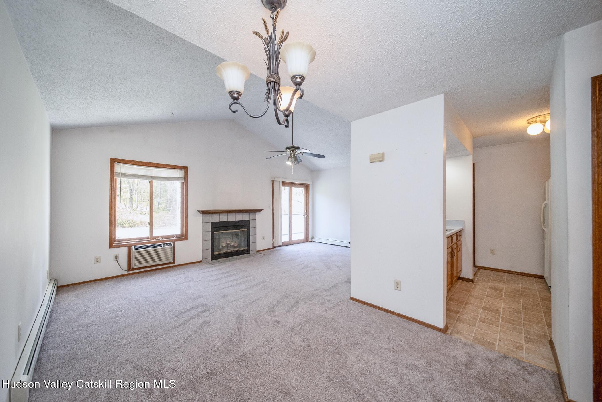 9 Rock Maple Road Saugerties, NY 12477 - Photo 3 of 30 a view of a livingroom with a fireplace chandelier and windows