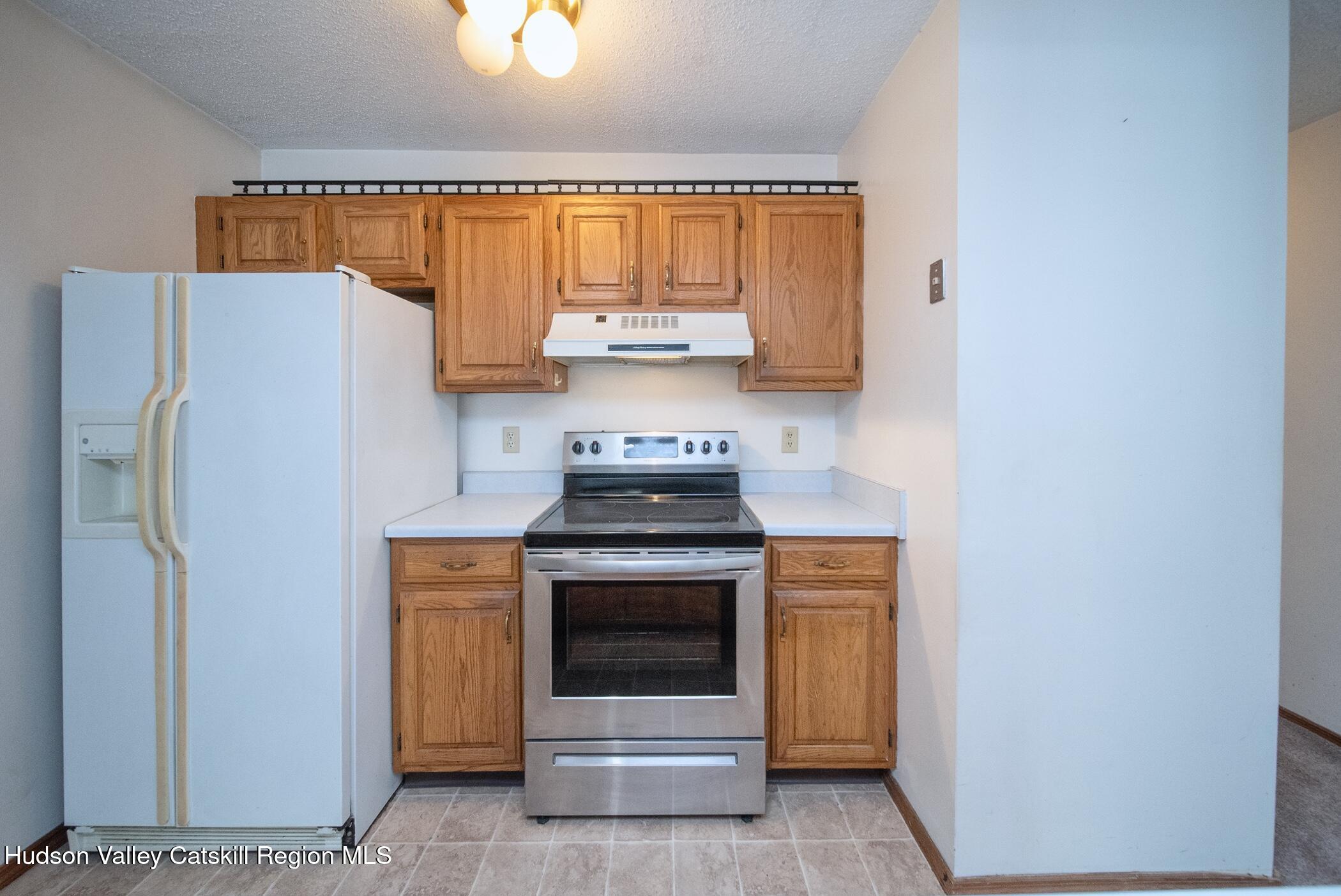 9 Rock Maple Road Saugerties, NY 12477 - Photo 7 of 30 a kitchen with a stove a refrigerator and a window